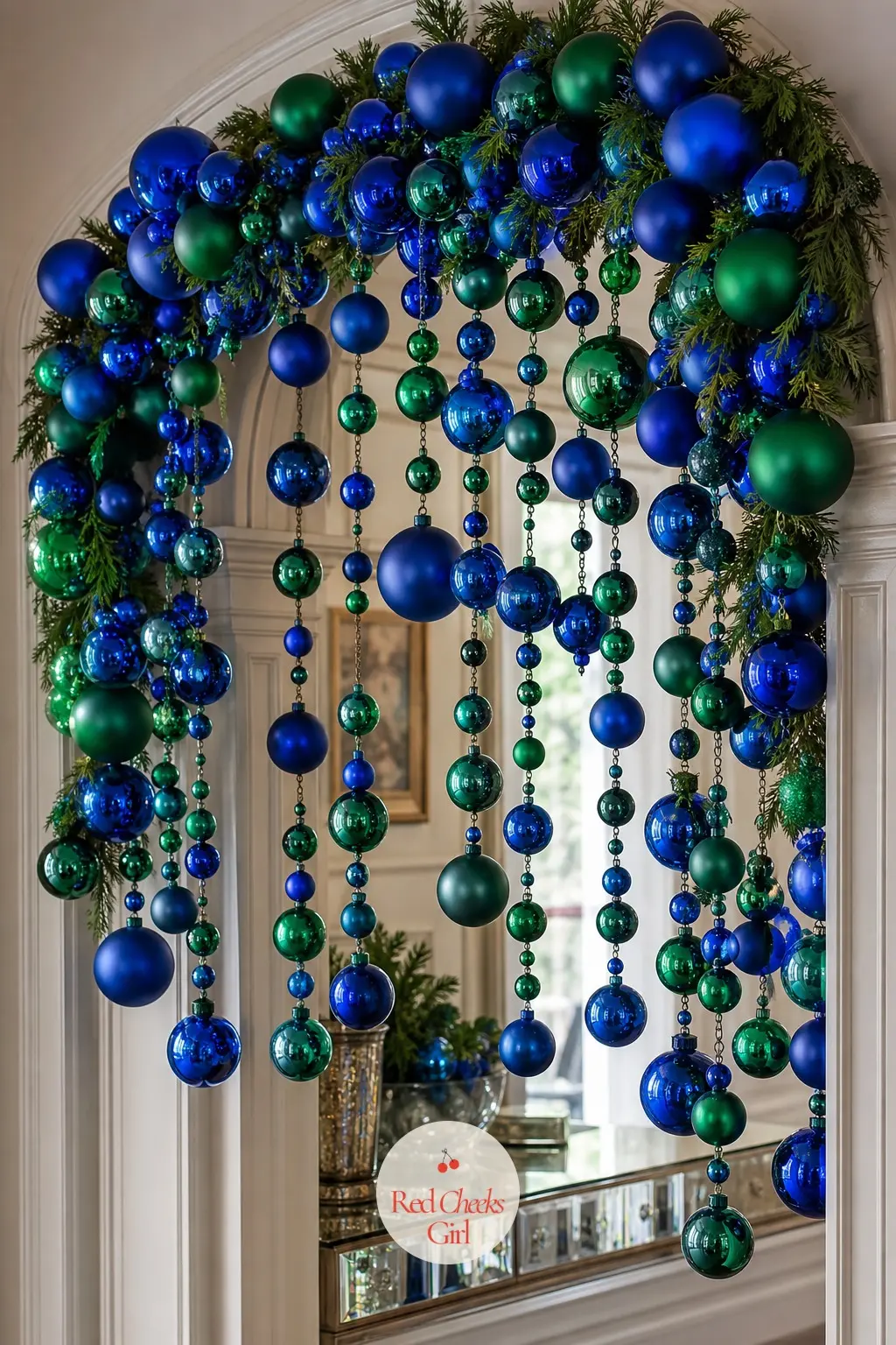 A Glass Ornament Cascade Archway in Sapphire and Emerald — Hang clusters of glass ornaments in sapphire and emerald from a thin wire run along the top of the