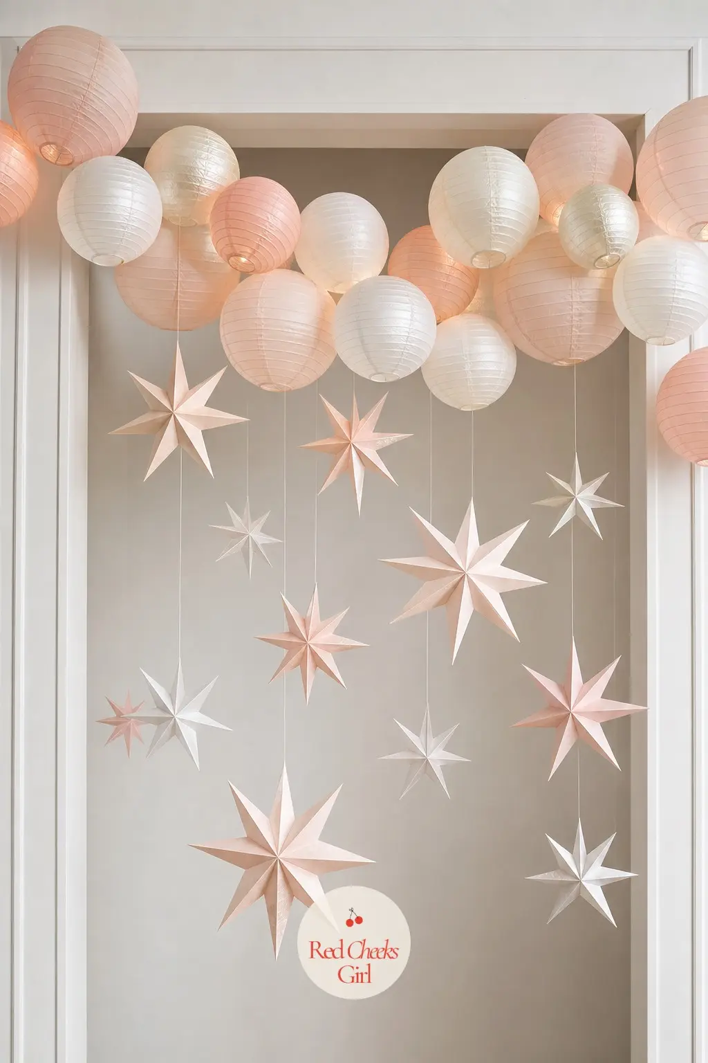 A Paper Lantern and Origami Star Archway in Blush and Pearl — For a doorway that wants nothing to do with pine, string a line of round paper lanterns in blush