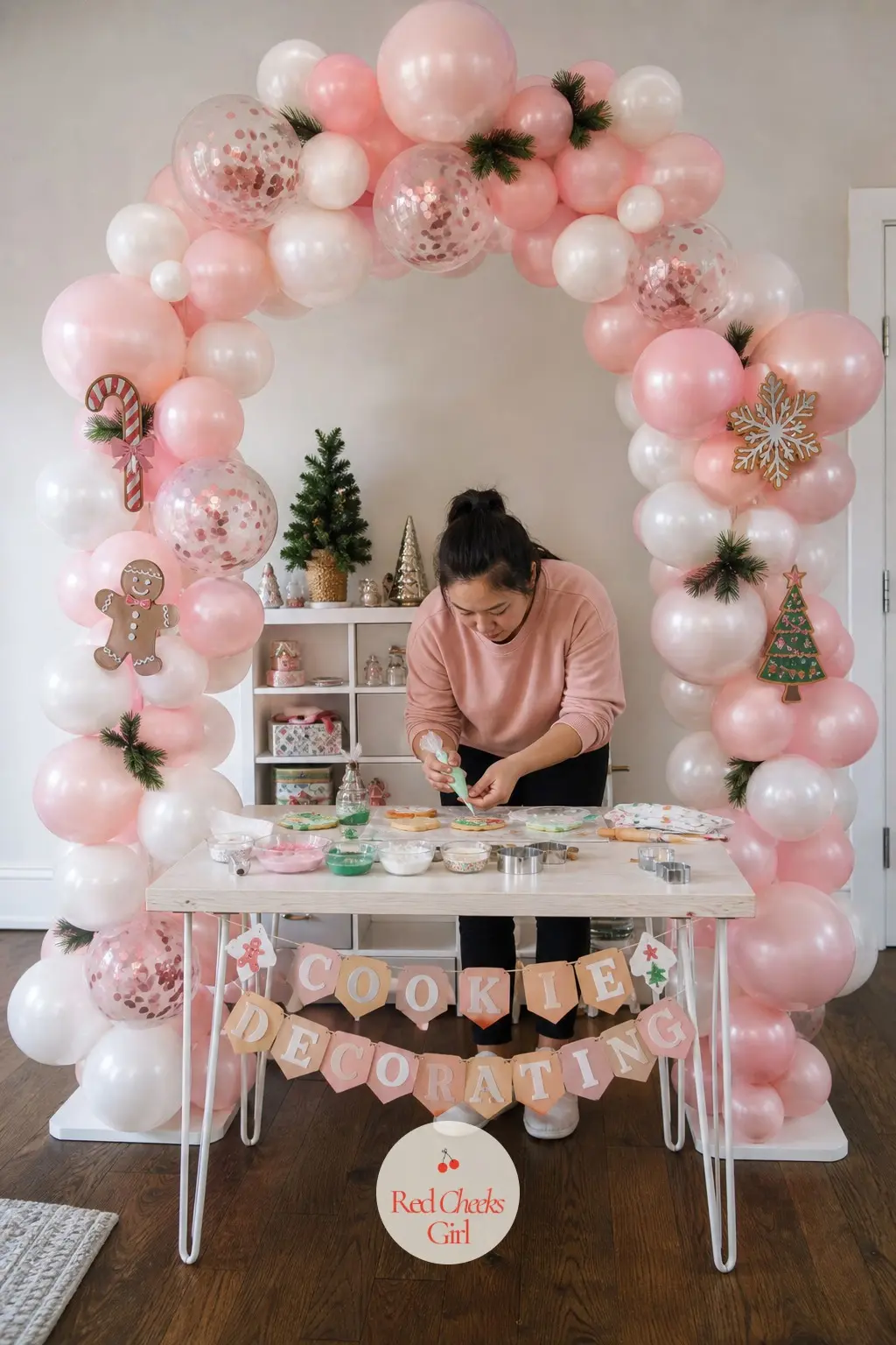 A Blush Pink and Pearl Balloon Arch Over the Cookie Decorating Table — Christmas does not have to mean red and green, and a table full of icing, sprinkles and