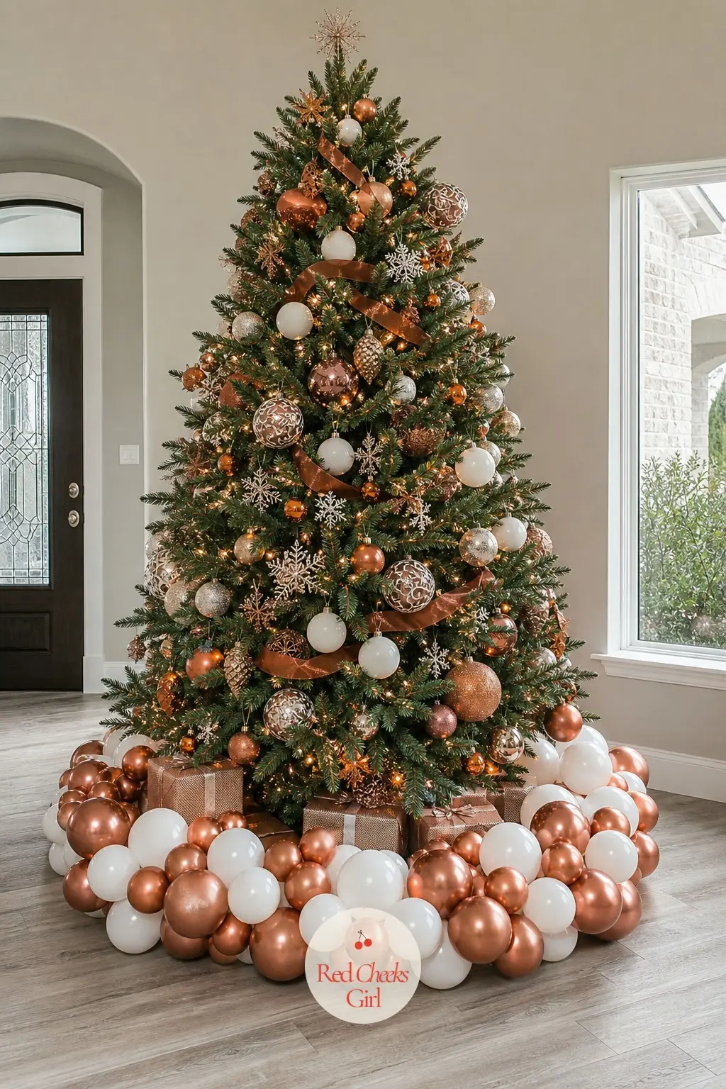 A Copper and White Balloon Ring Around the Tree Base — An arch does not have to stand upright. Christmas balloon arch