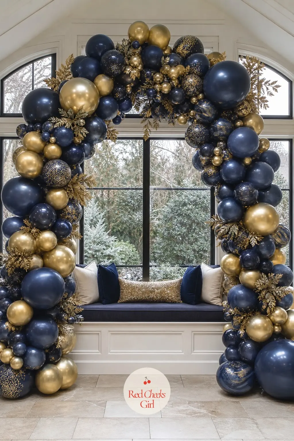 A Midnight Blue and Gold Balloon Arch Over the Sunroom Window Seat — Midnight blue against a dark winter window disappears a little at night, which is exactly