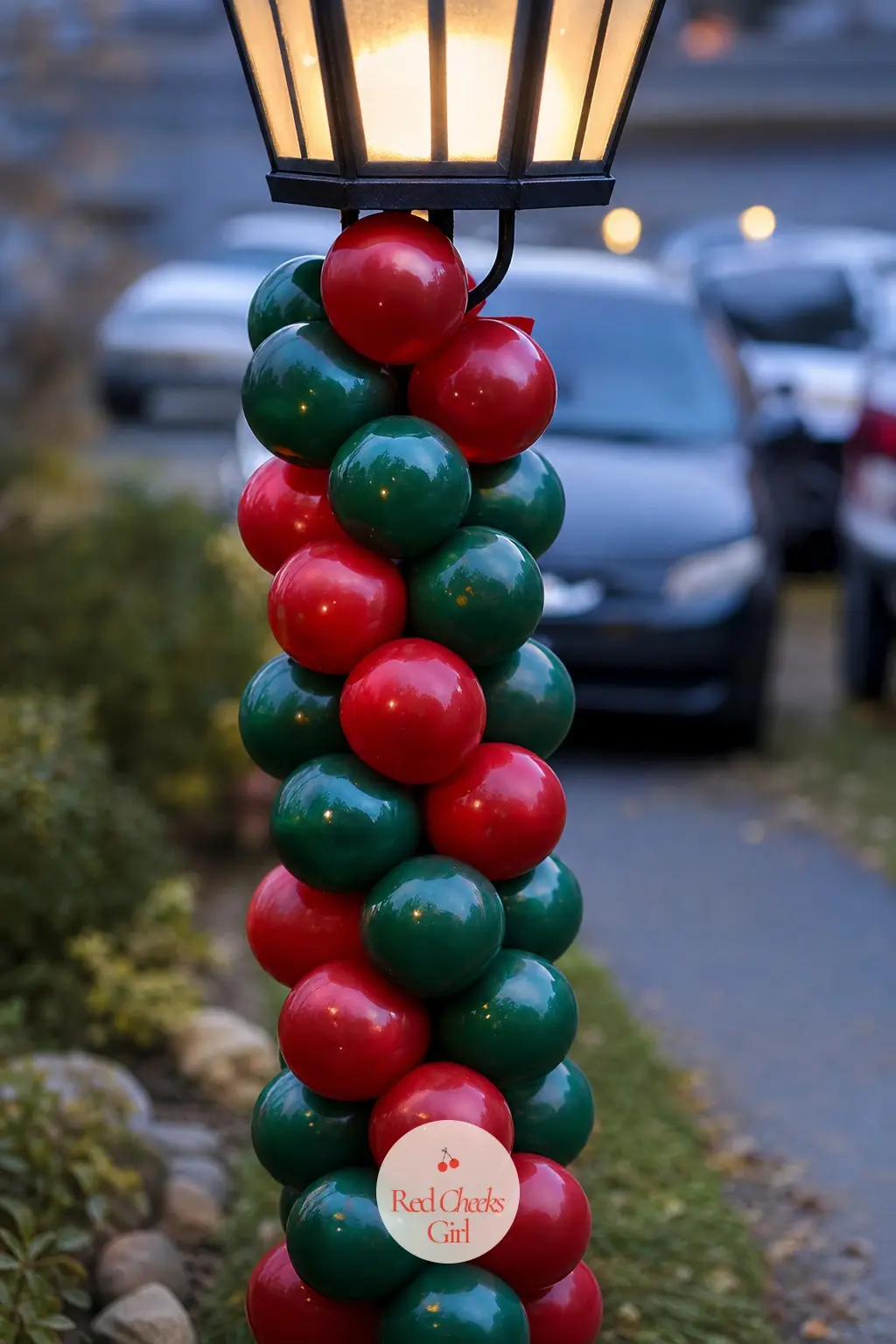 A Pine Green and Berry Red Balloon Spiral Up the Driveway Lamppost — Wrapping balloons in a tight spiral up a pole is a different build than looping an arch