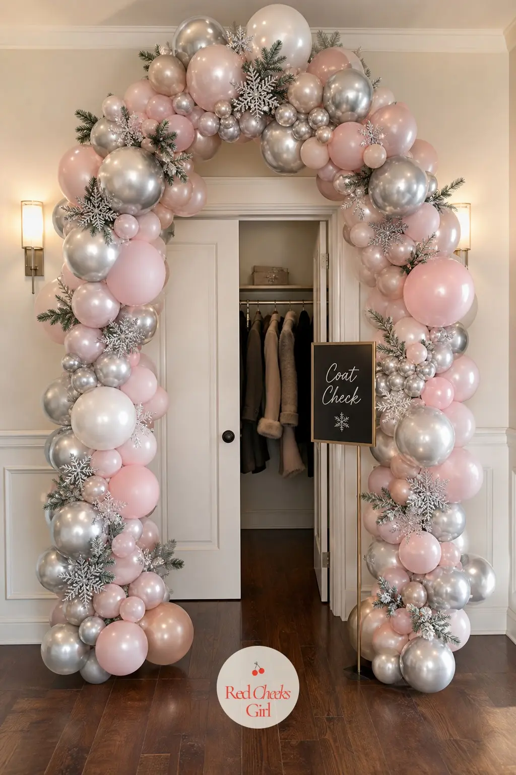 A Platinum and Blush Balloon Arch Framing the Coat-Check Corner — Nobody decorates the spot where coats pile up, which is exactly why this one gets noticed.
