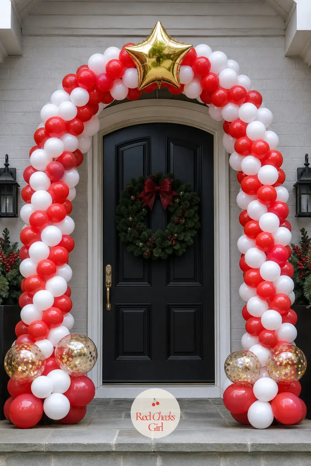 A Candy Cane Striped Balloon Arch Framing the Front Door — An organic arch built from red and white balloons in alternating sizes curves over the door frame