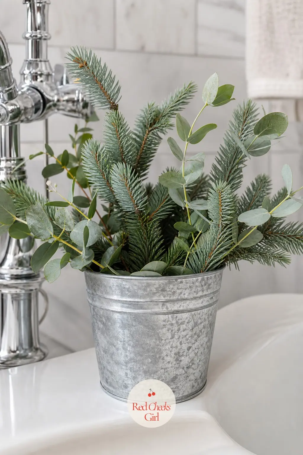 A Galvanized Bucket of Fresh Eucalyptus and Blue Spruce Stems Set on the Tub Ledge — A small galvanized bucket, packed loosely with fresh eucalyptus and blue