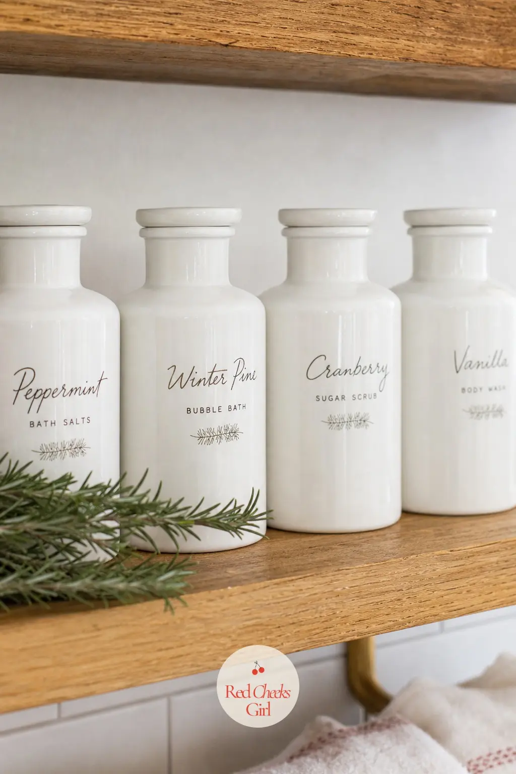 An Open Shelf Styled With White Ceramic Apothecary Bottles Relabeled by Hand for the Season — Decant everyday bathroom products, shampoo, lotion, mouthwash