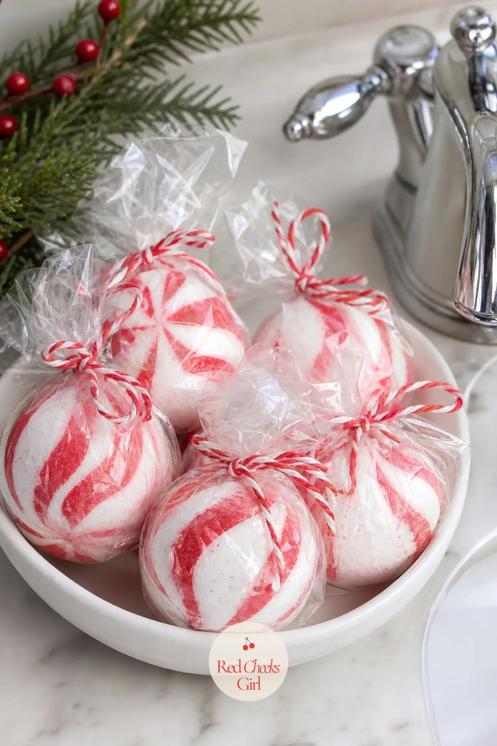 A Shallow Dish of Individually Wrapped Peppermint Bath Bombs Set Beside the Sink Tap — A shallow dish beside the tap, filled with individually wrapped