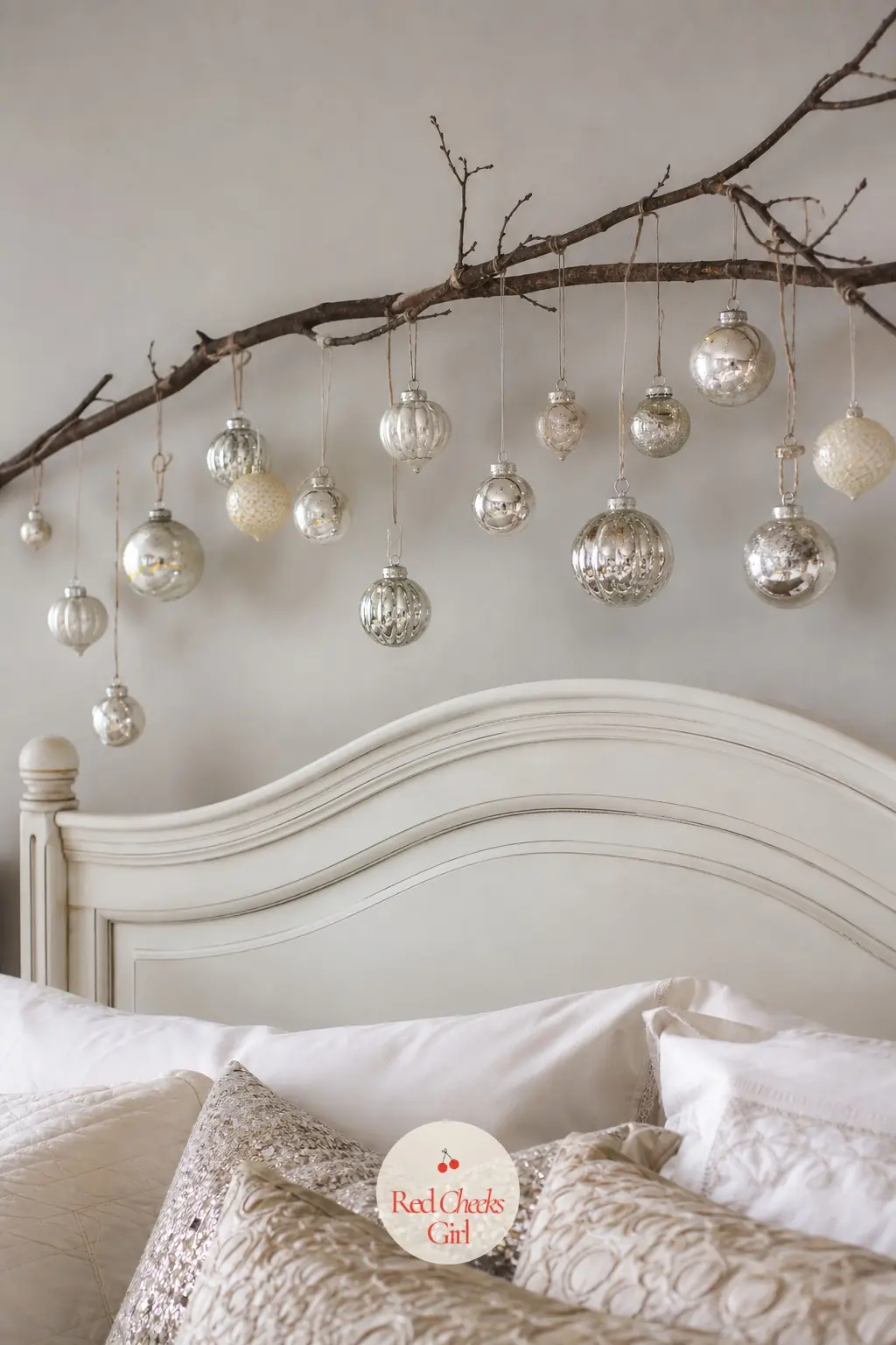 A Curved Branch Hung Above the Headboard Strung With Mercury Glass — A bare curved branch, the kind you can cut from the garden or buy dried by the bundle