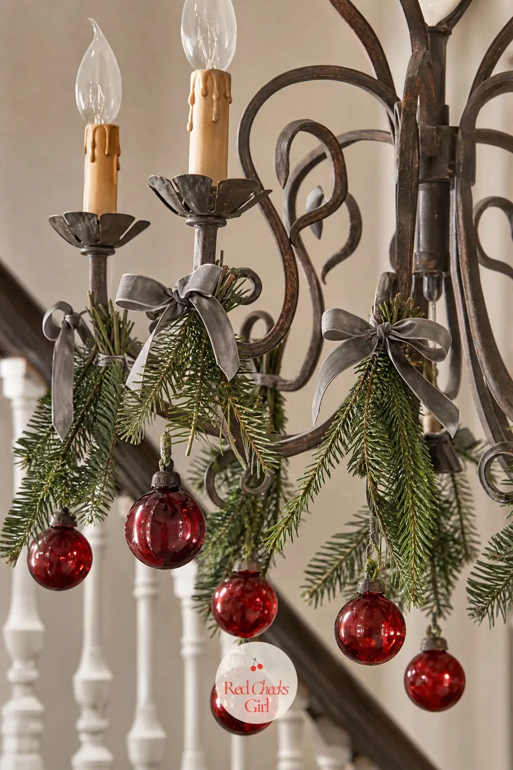 Cranberry Glass and Fir Sprig Candle Chandelier — A candle style chandelier over a stairwell landing already looks like firelight, so lean into it with