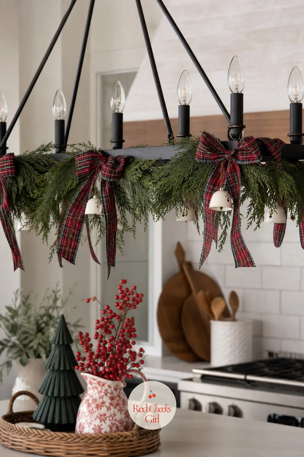 Tartan Ribbon and Cedar Linear Island Chandelier — A linear chandelier over a kitchen island gets a full length of red and black tartan ribbon tied in bows at