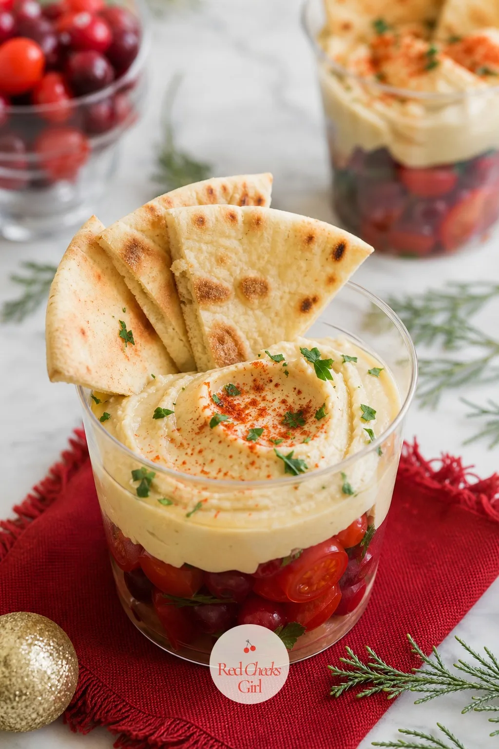 Hummus and Pita Cup — A swirl of cream hummus dusted with red paprika and a scatter of green parsley gives this cup more personality than its short ingredient