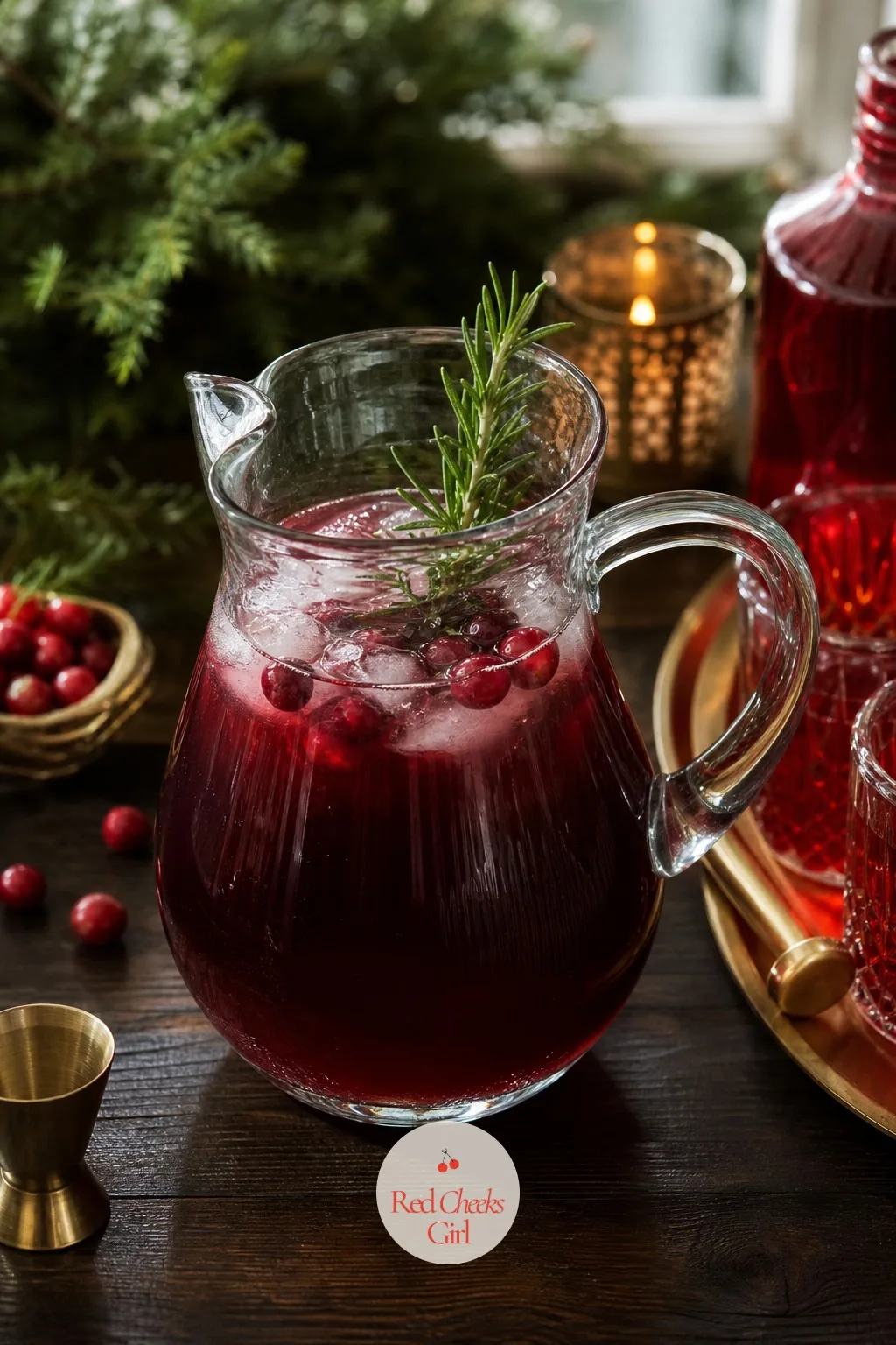A Batched Cranberry Rosemary Cocktail in a Glass Pitcher — One drink, made once, for everyone: this is the entire point of a signature cocktail. Christmas