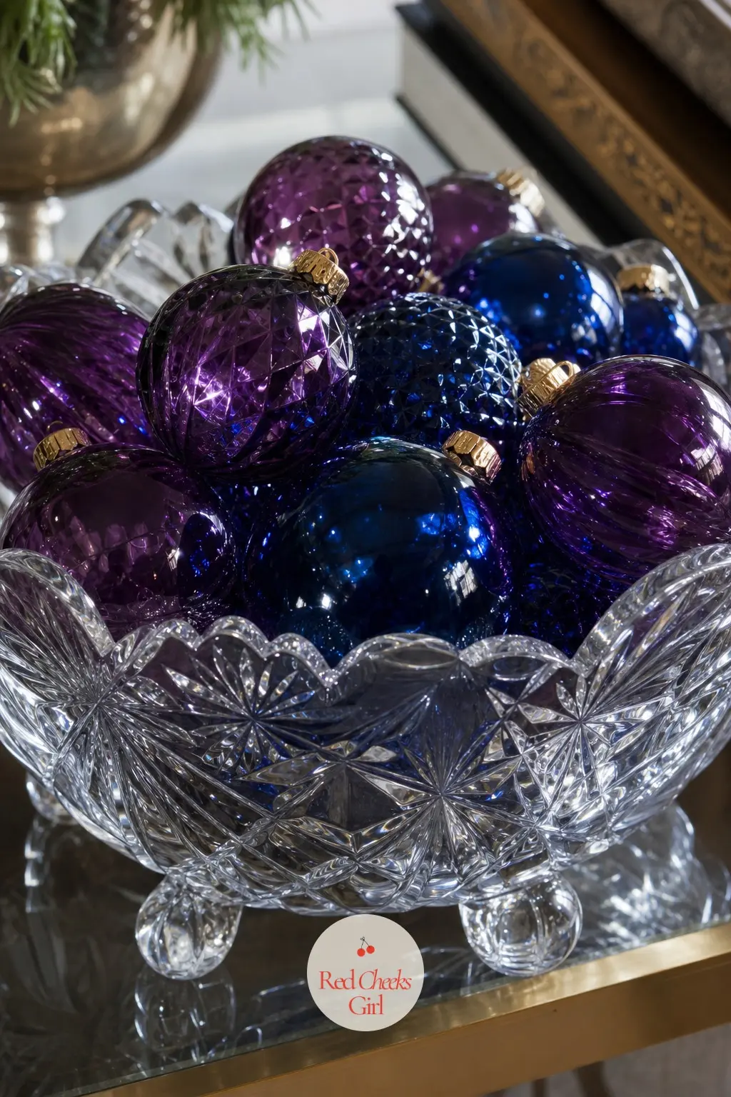 A Cut Crystal Bowl of Sapphire and Amethyst Ornament Balls — A heavy cut crystal bowl sits filled with glass ornament balls in deep sapphire blue and amethyst