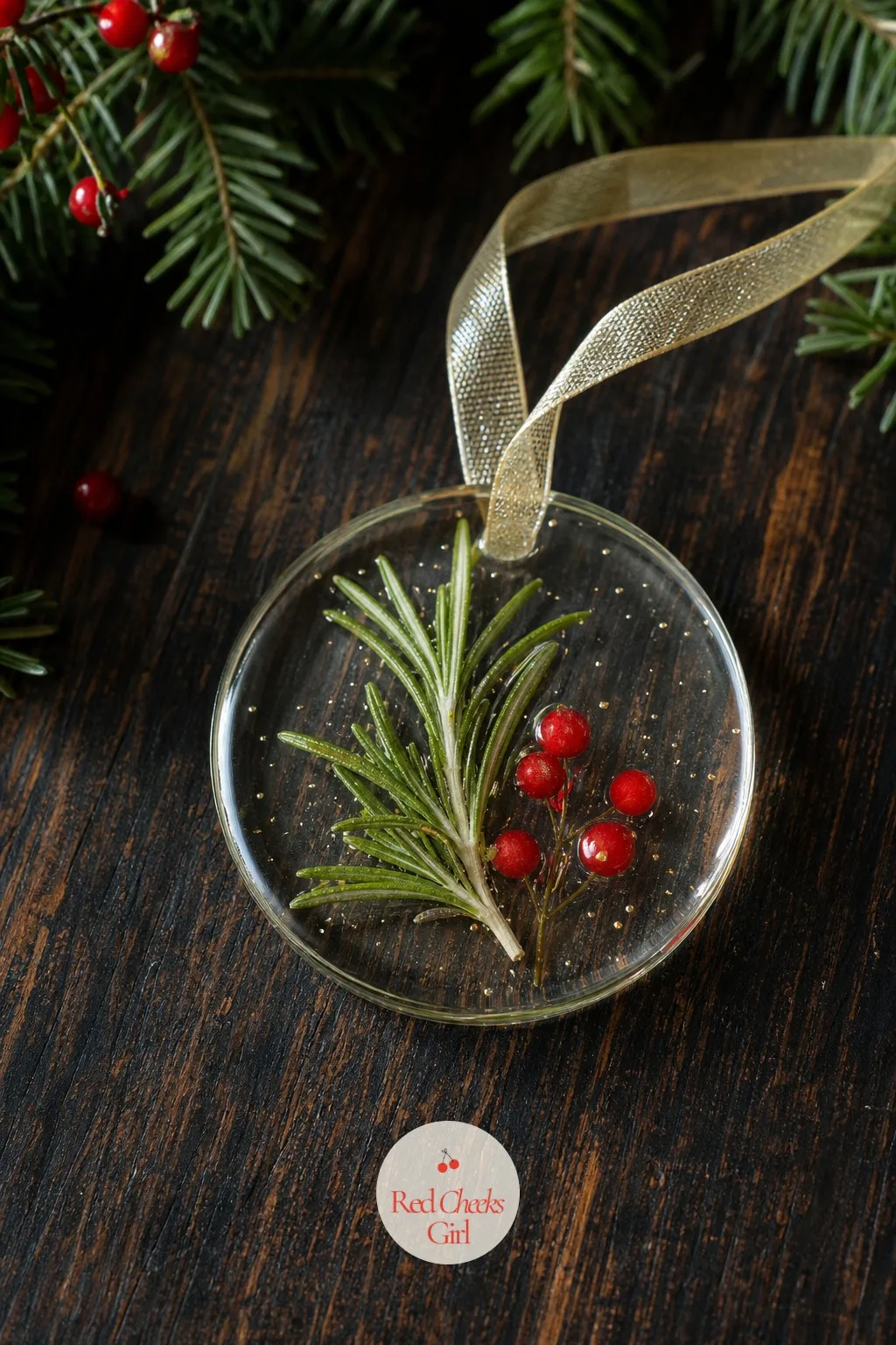 Rosemary and Berry Resin Ornament — A sprig of actual rosemary pressed flat and sealed in clear resin keeps its colour and its shape long after the fresh stem