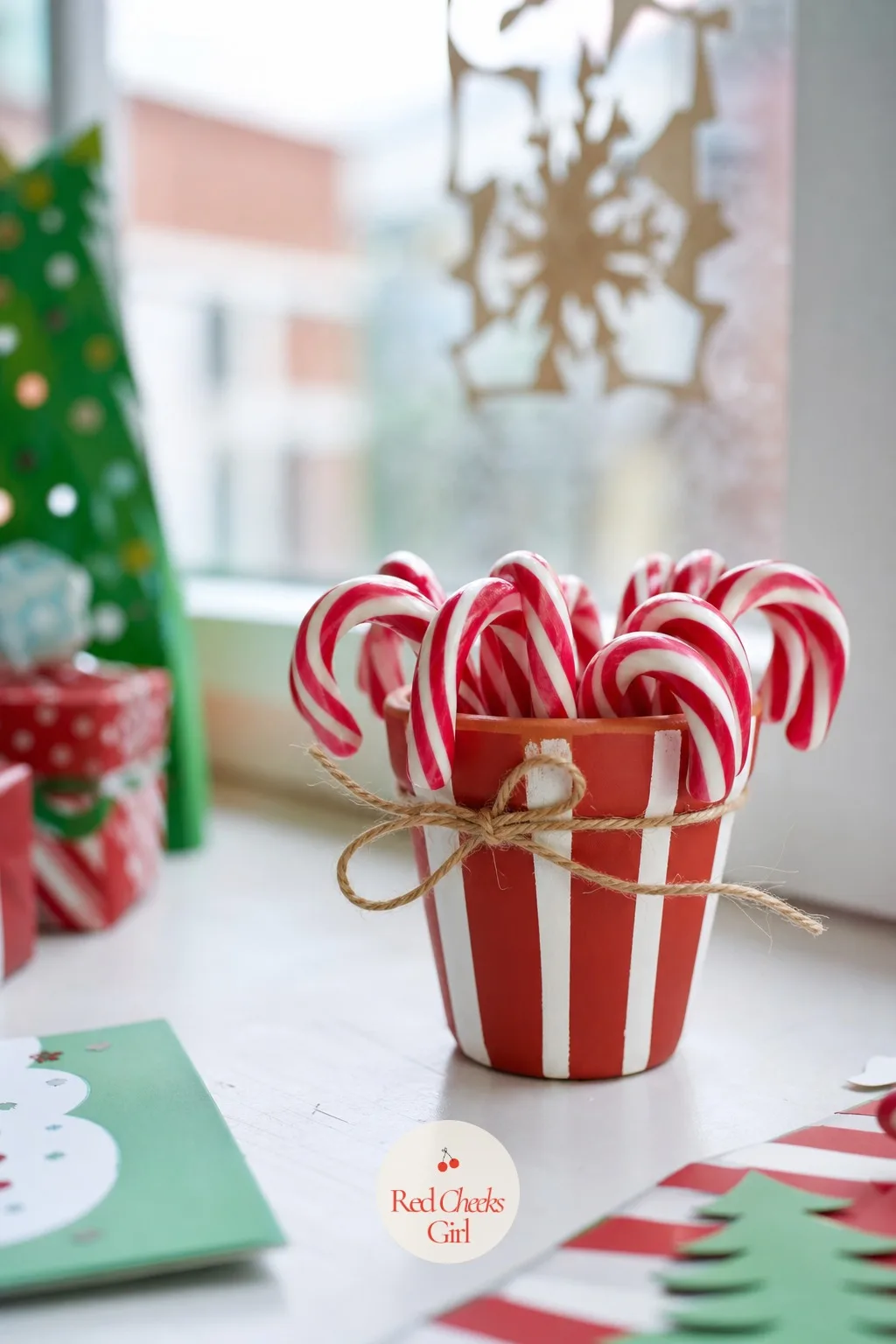 Mini Terracotta Candy Cane Pots — An empty terracotta pot looks like a gardening leftover. Christmas crafts for kids at school