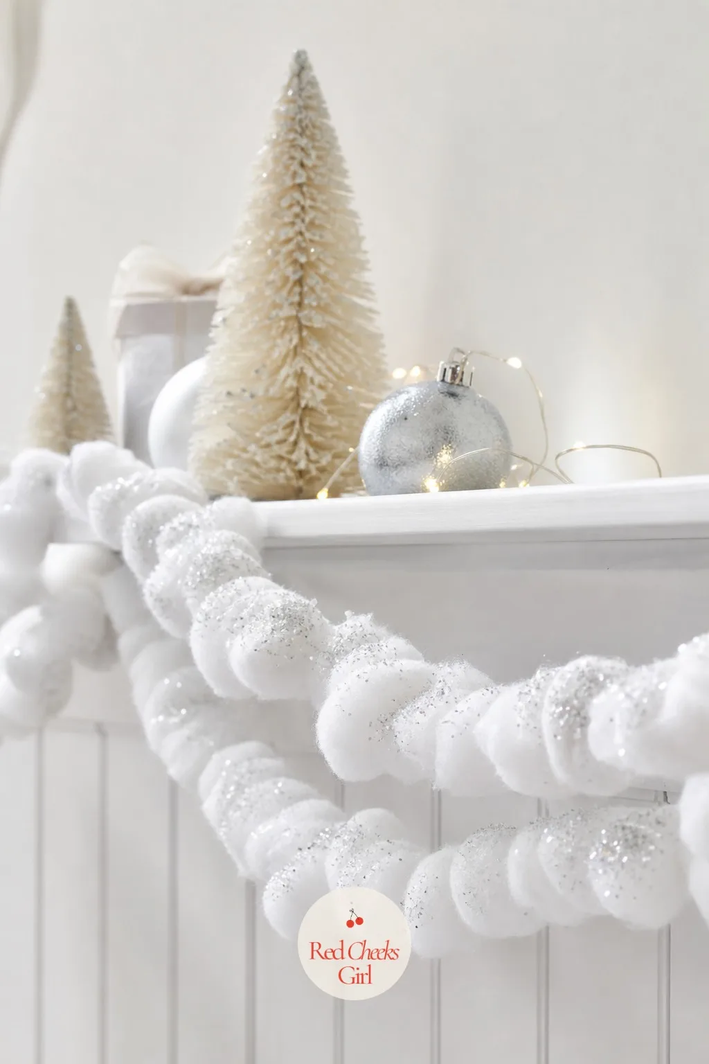 Cotton Ball Snowstorm Garland — Cotton balls threaded loosely onto a length of string and dusted with a pinch of silver glitter make a fluffy garland that a