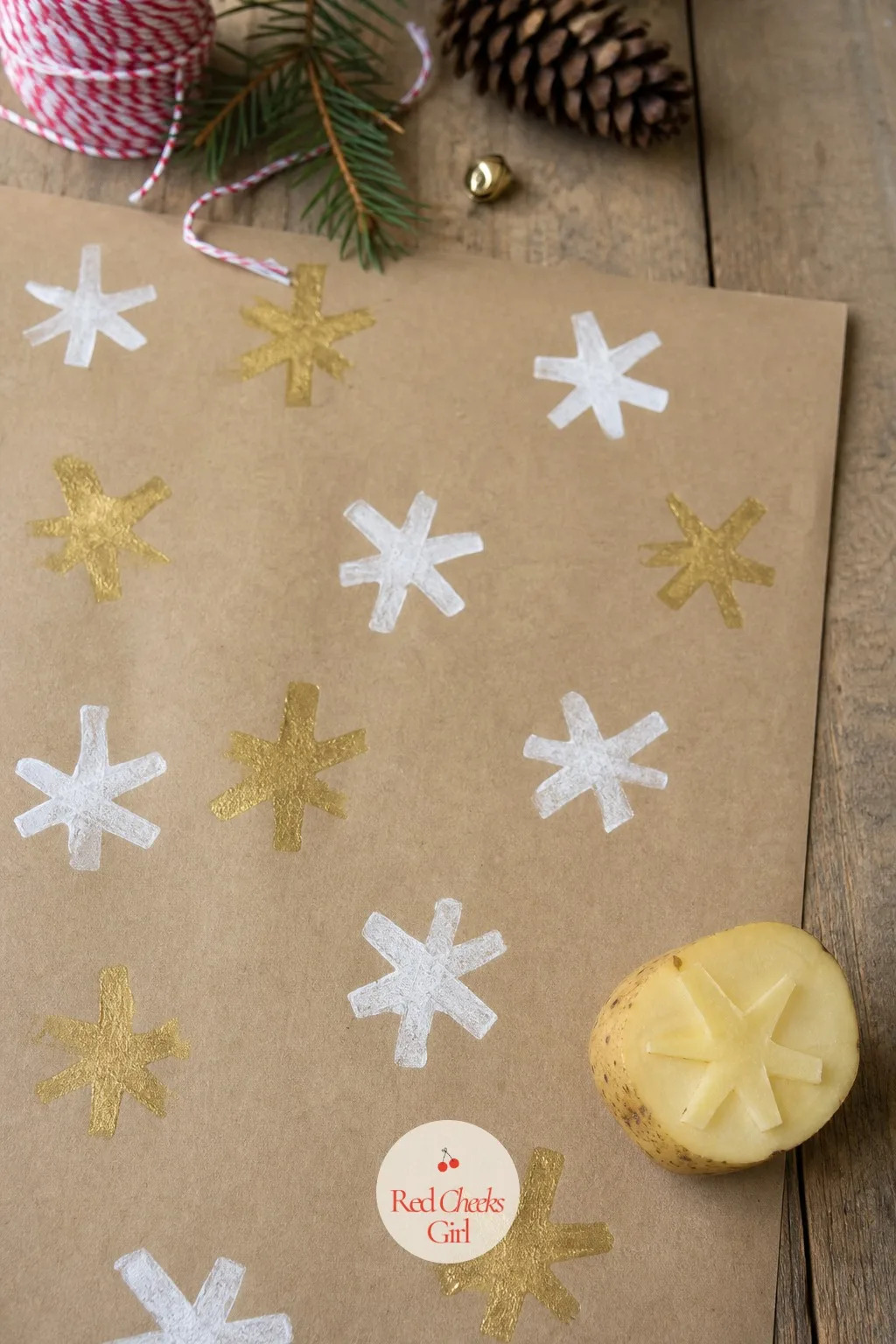 Potato-Stamp Star Wrapping Paper — Half a potato, a star cutter pressed into the cut face, and a plate of gold paint turns a roll of kraft paper into wrapping