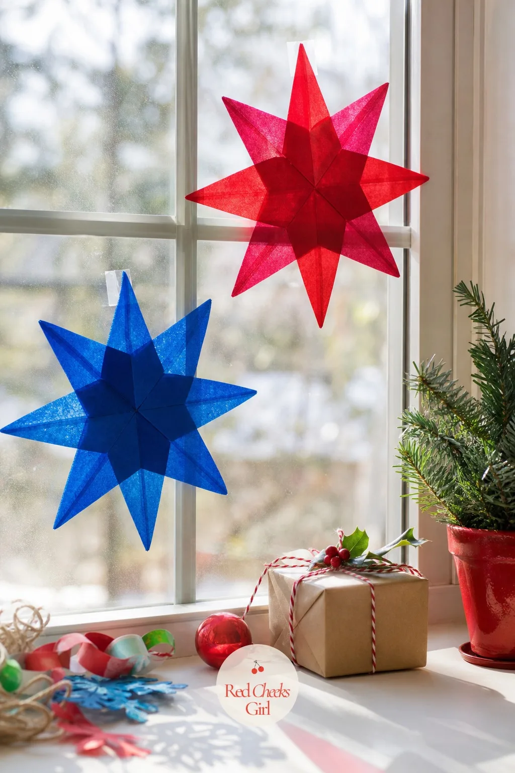 Tissue Paper Suncatcher Stars — Scraps of ruby red and sapphire blue tissue paper pressed between two layers of clear contact paper, then trimmed into a star