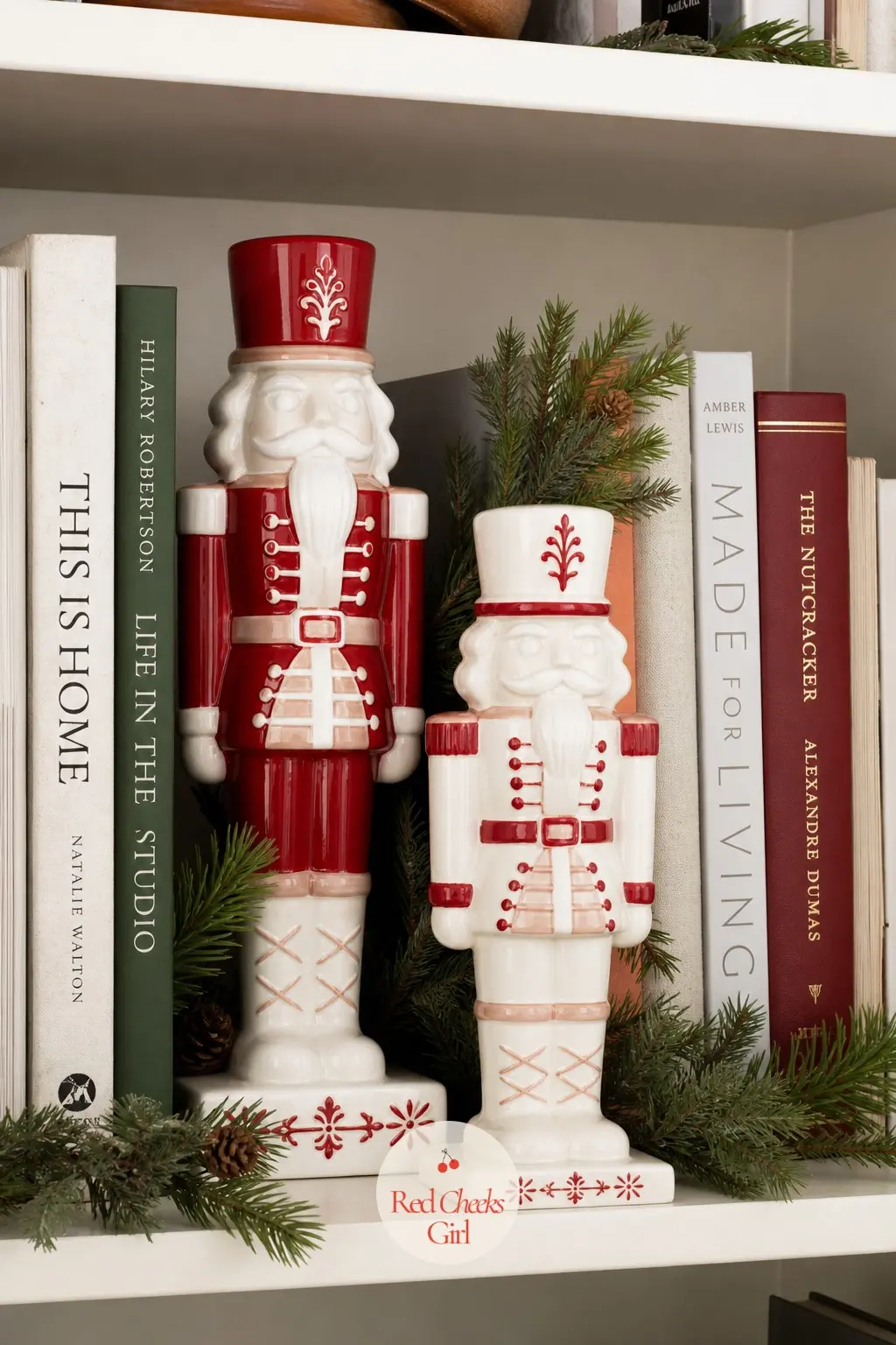 A Bookshelf Edited Down to Ceramic Nutcrackers and Pine Sprigs — Before adding anything, remove a third of what is already on the shelf. Christmas decor ideas