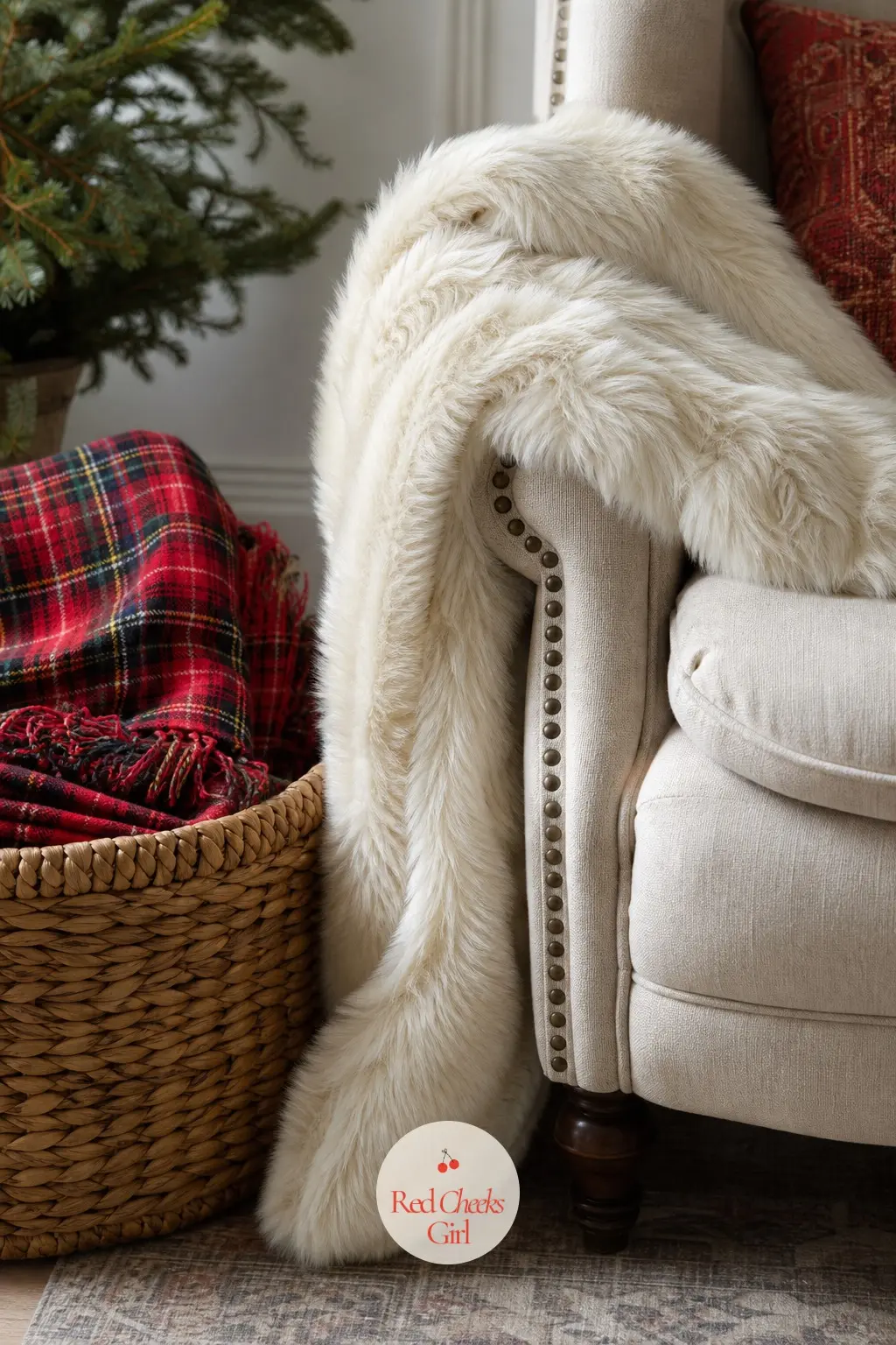 A Faux Fur Throw Draped Over a Reading Chair with a Tartan Blanket Basket — One ivory faux fur throw draped loosely over the arm of a reading chair, with a