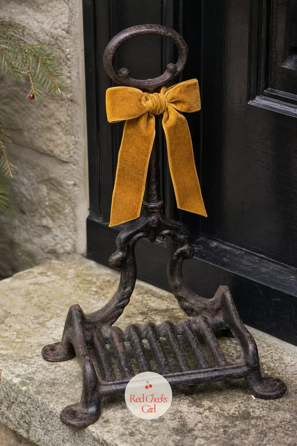 A Cast Iron Boot Scraper Dressed With a Mustard Velvet Bow — The one tool nobody thinks to decorate: a cast iron boot scraper by the door takes a single small