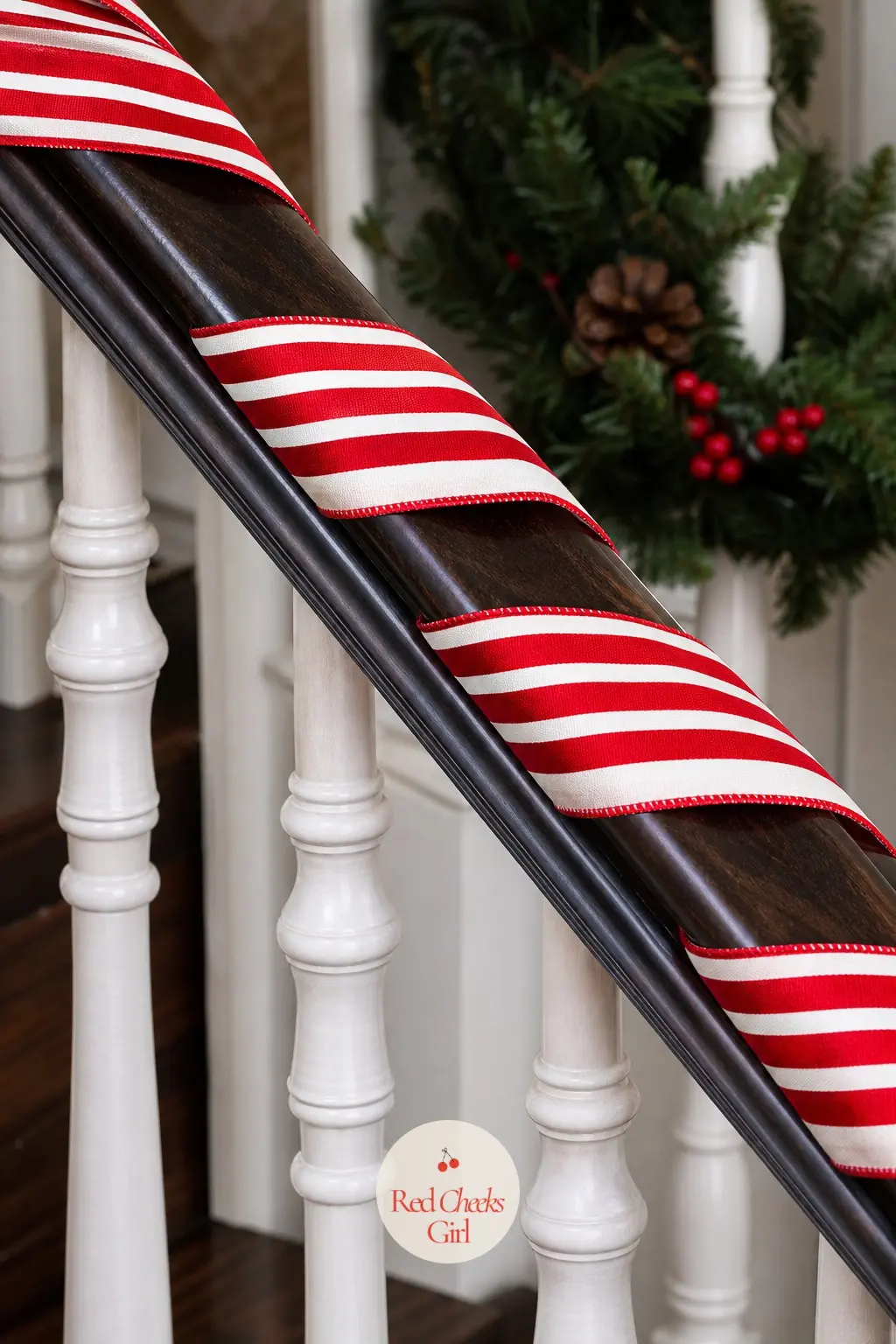Candy Cane Striped Ribbon Garland — A red and white candy cane striped ribbon spiraled around a staircase banister is bold, graphic, and instantly readable