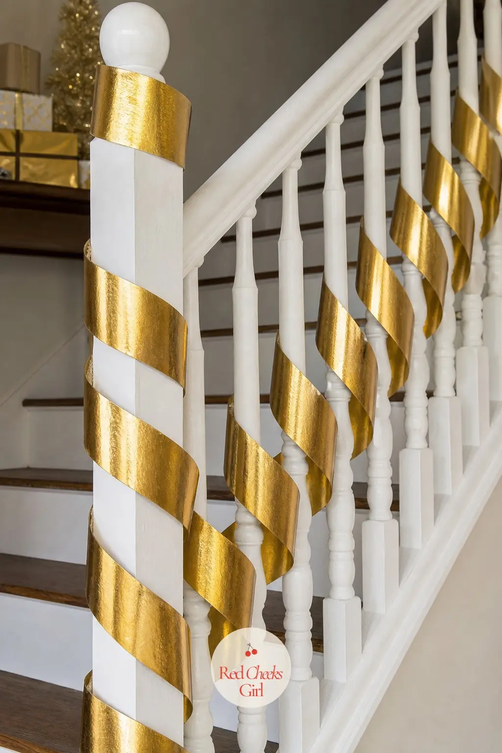 Gold Ribbon Spiral — Skip greenery entirely and wind a wide gold metallic ribbon in a tight spiral from the top of the staircase to the bottom. Christmas