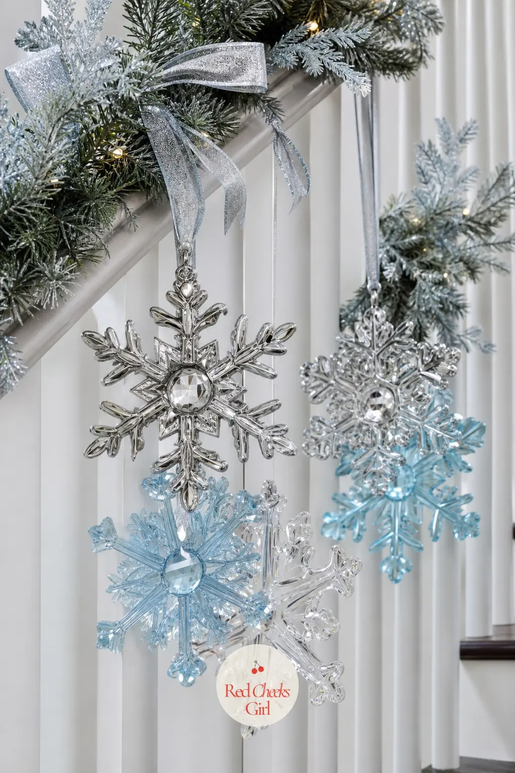 Snowflake Ornament Clusters on an Icy Blue and Silver Garland — For a staircase that leans more winter wonderland than classic red and green, group icy blue