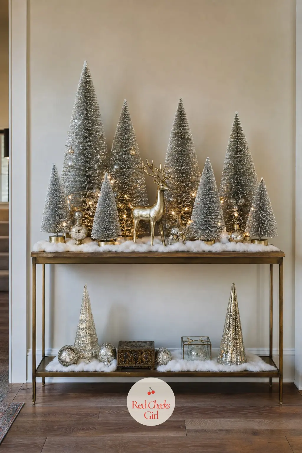 A Console Styled as a Miniature Village With Glass Bottle Brush Trees — Instead of a candle and a bauble bowl, the console becomes a small winter scene: silver