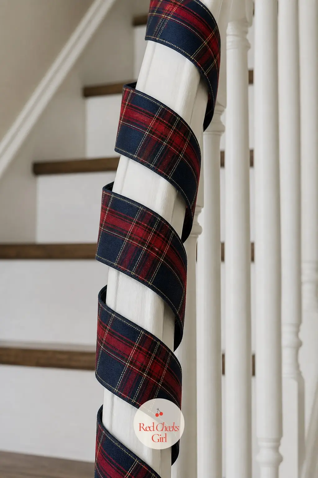 A Length of Tartan Ribbon Spiraled Down the Bannister Without Any Greenery — Skip the foliage entirely and wind a wide tartan ribbon around the bannister rail
