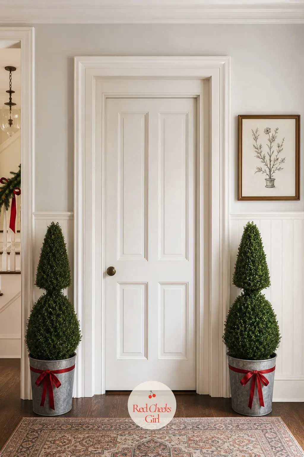 Twin Boxwood Topiaries in Weathered Zinc Pots Either Side of the Door — Two matched topiaries either side of an interior door do what a single wreath cannot
