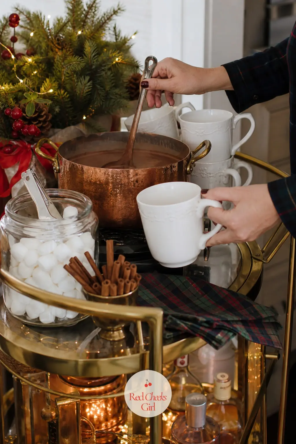 A Bar Cart Hot Cocoa Station With a Copper Pot Kept at a Simmer — A small bar cart rolled into the corner holds a copper pot of cocoa kept warm on low heat, a