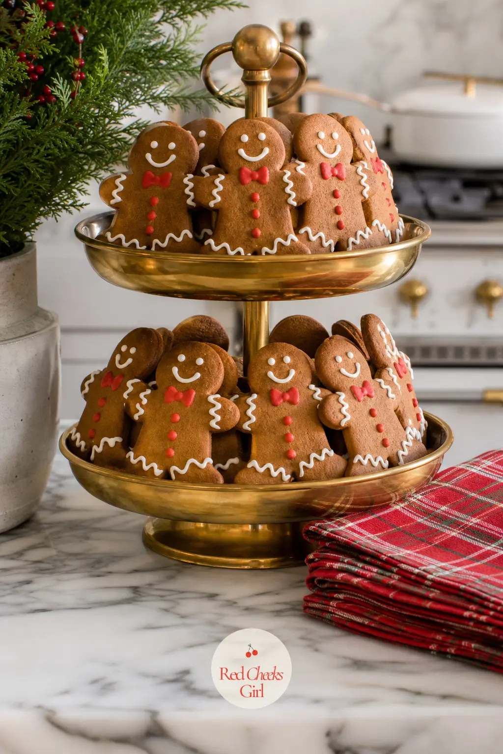 A Brass Tiered Stand of Iced Gingerbread Men on the Island Corner — A brass tiered stand at the corner of the island holds rows of iced gingerbread men in