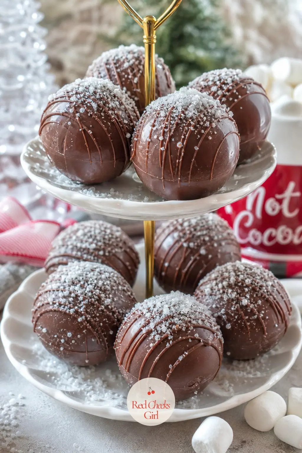 A Tiered Stand of Cocoa Bombs Dusted With Edible Snow — Cocoa bombs have become a cocoa corner staple for a reason, and a tiered stand dusted with edible sugar