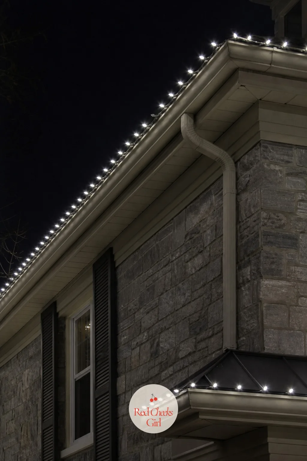Mini Lights Tracing the Gutter Line in Cool White — Cool white reads differently to warm white, closer to moonlight than candlelight, and it suits a house with