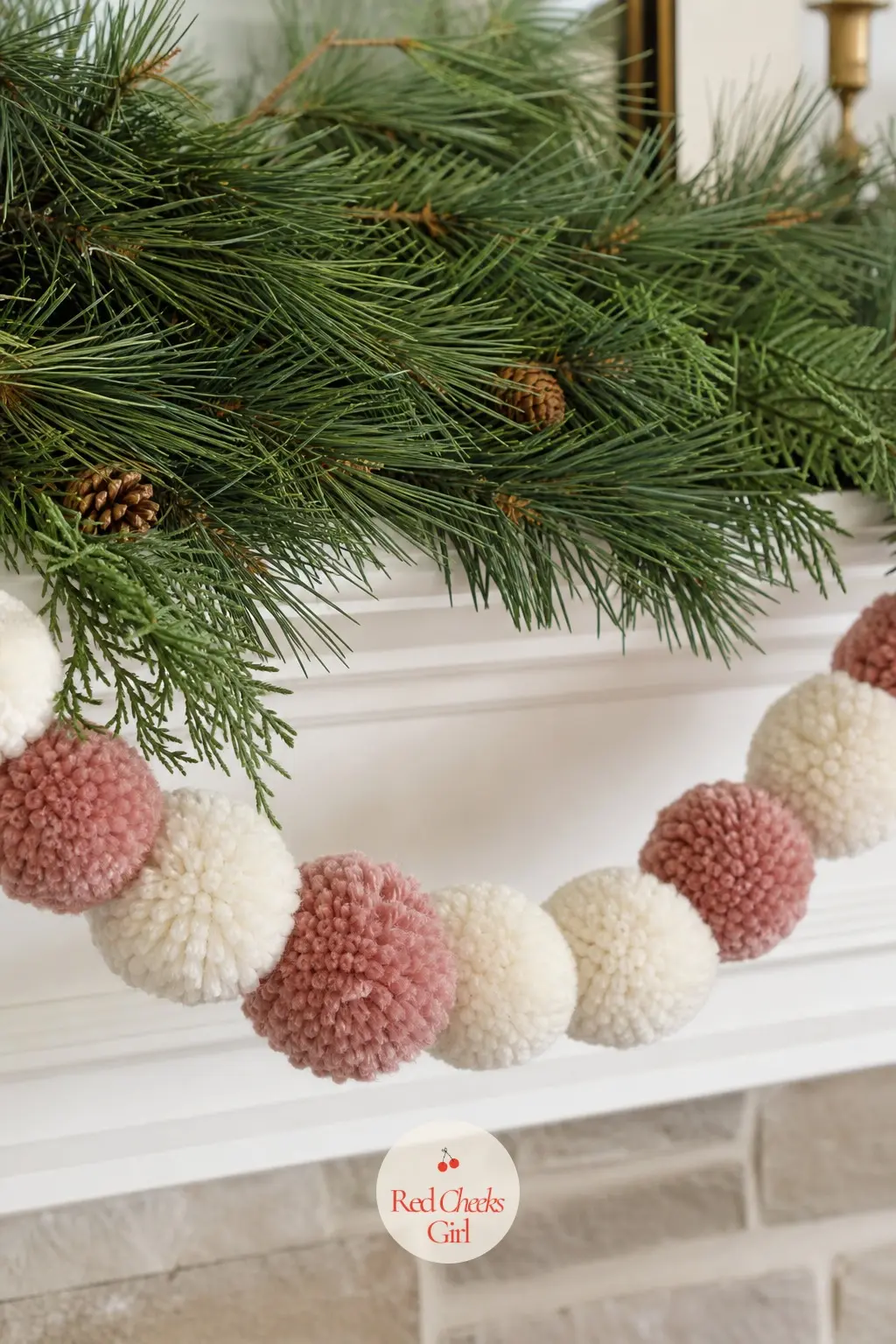 A Chunky Wool Pom Garland Looped Beneath the Greenery — Wool pom garland in cream and dusty pink gives a soft, handmade texture that reads as Scandinavian