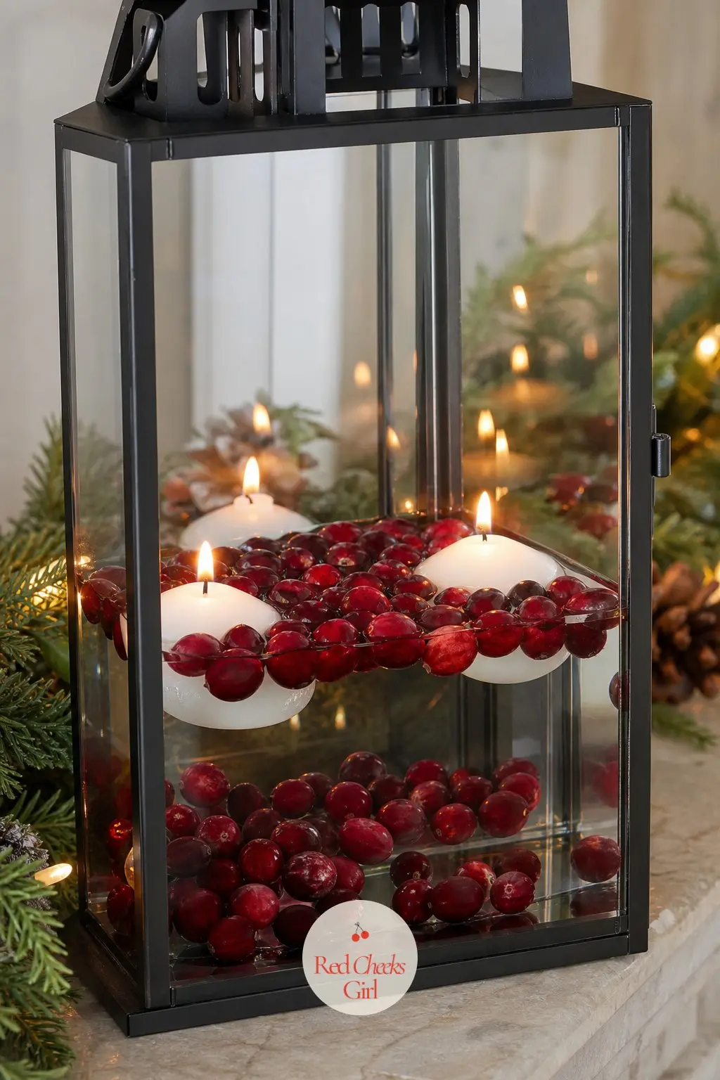A Lantern Filled With Floating Candles and Cranberries — A tall glass lantern filled with water, floating candles and fresh cranberries sits as a single