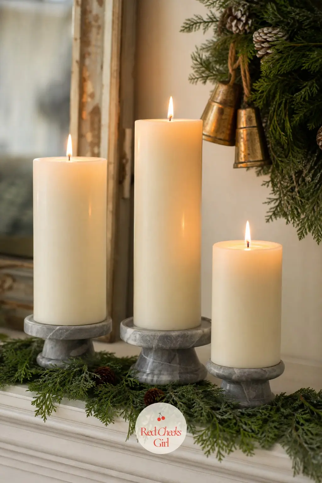 A Trio of Fat Pillar Candles Set on Marble Risers — Three candles at three different heights do more for a mantel than ten scattered at the same level.