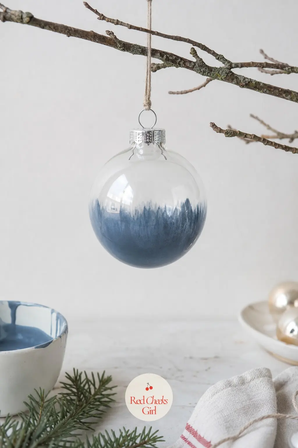 Ombre Dip Ball — Dusty blue paint thinned slightly with water, dipped so only the bottom third of the ball takes colour, the rest left clear or frosted white.