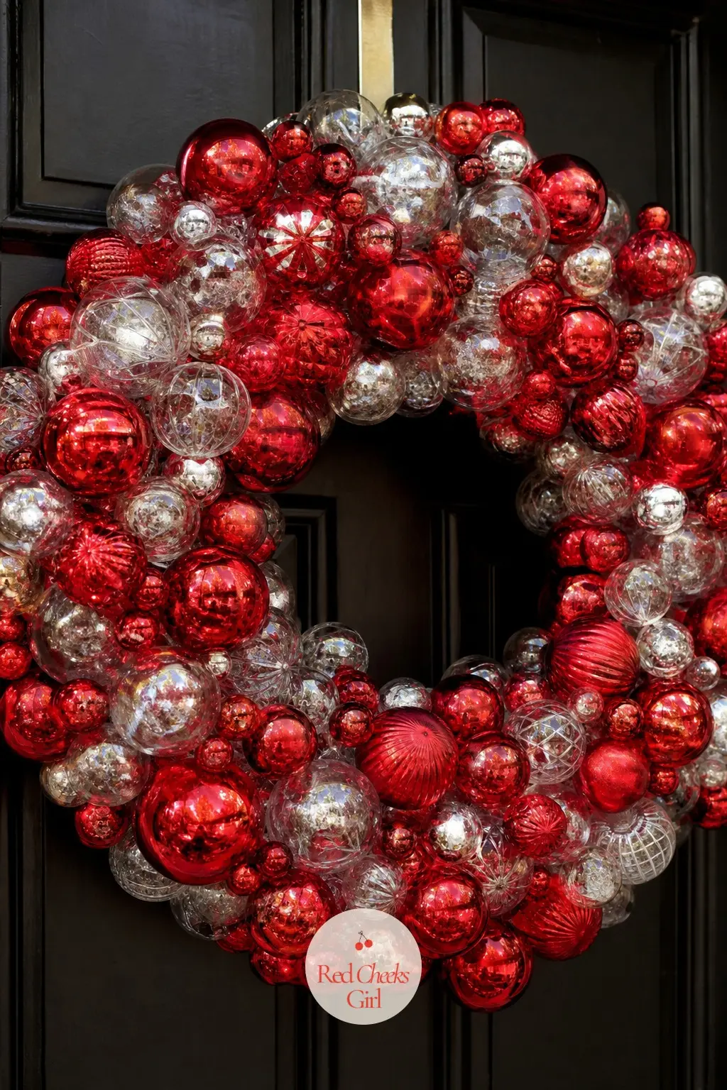 The Ruby Red and Clear Glass Bauble Wreath for the Front Door — Ruby red glass balls in three sizes cluster against clear glass ones on a wire form, so the red