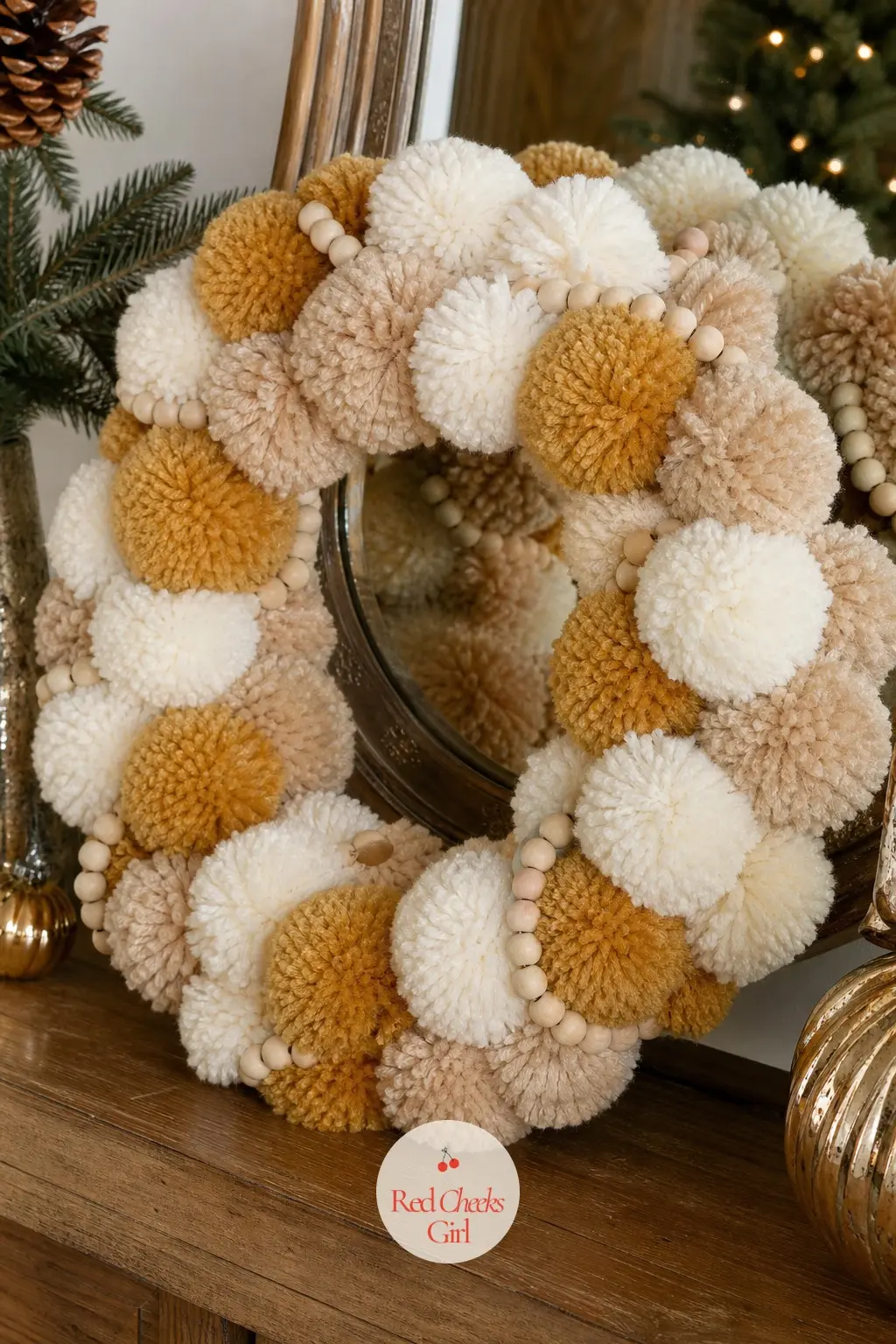 The Butterscotch Gold and Cream Pom Pom Wreath for the Foyer Console — Butterscotch leans warmer than true orange and sits beautifully against cream, which is