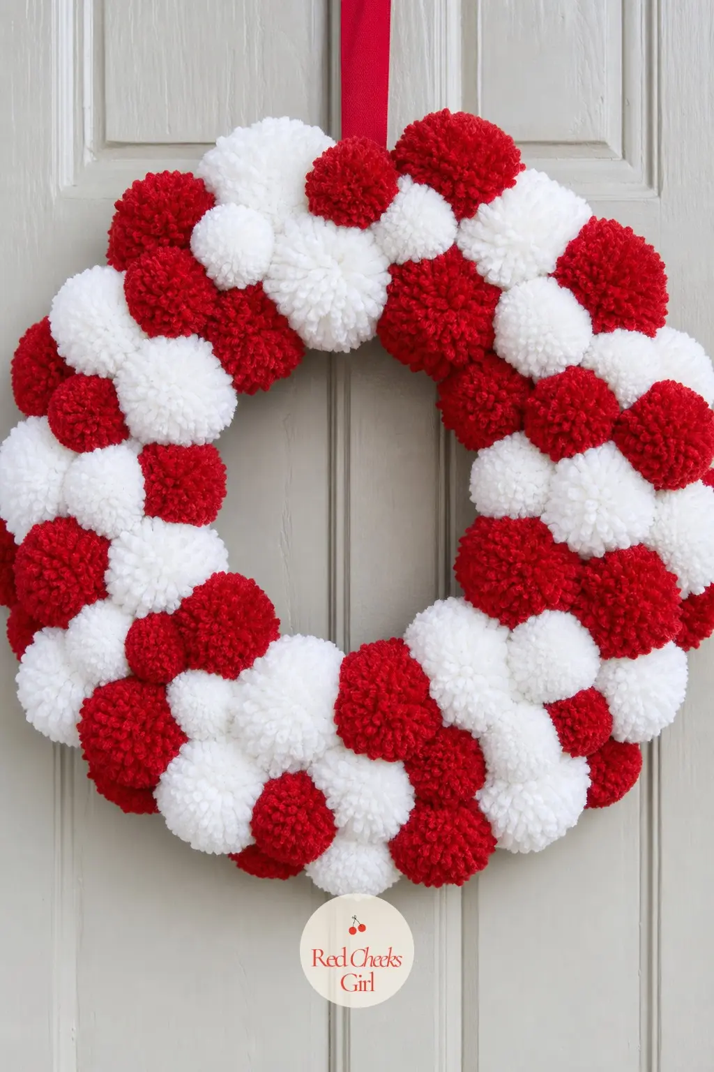 The Cherry Red and Marshmallow White Pom Pom Wreath for the Front Door — This is the classic candy color pairing done properly: cherry red pom poms packed in