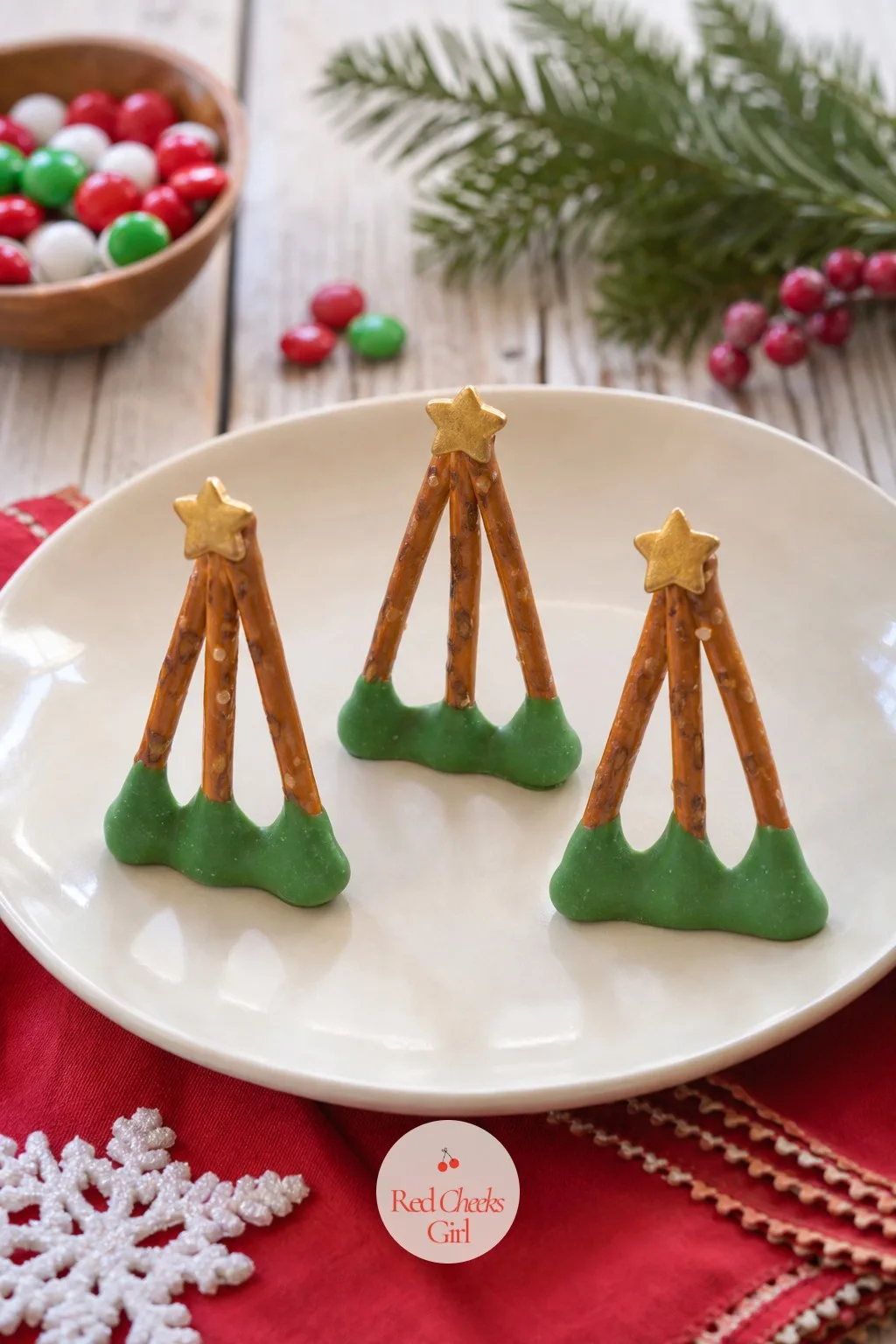 Pretzel Christmas Trees — Three pretzel sticks of decreasing length, fanned out and dipped at the base in green candy melt, make a tree shape without a single