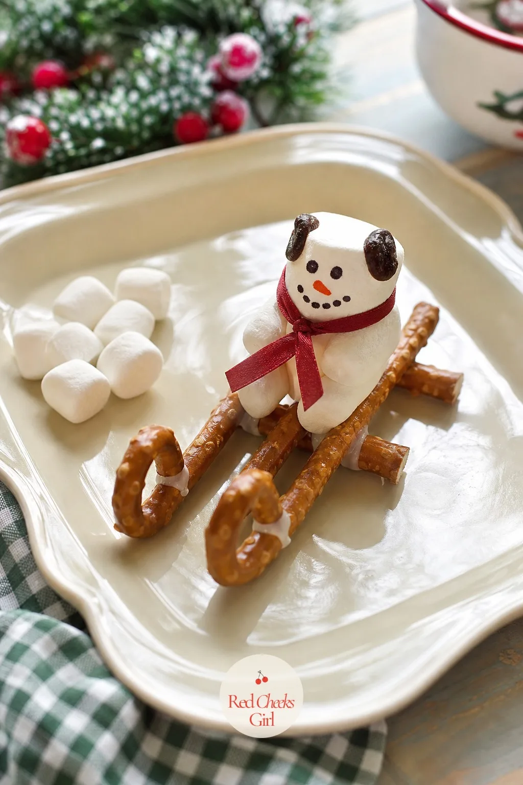 Pretzel Sleds with Marshmallow — Same sled base, different passenger: a large marshmallow stood on end, with a tiny dot of icing for a face, rides on top