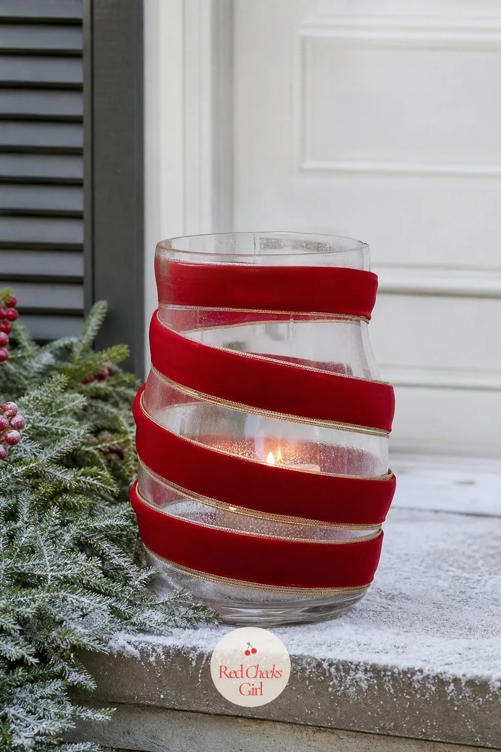 Ribbon-Wrapped Hurricane Lantern for the Porch — A bare glass lantern left by the door looks like patio furniture nobody put away for winter. Christmas ribbon