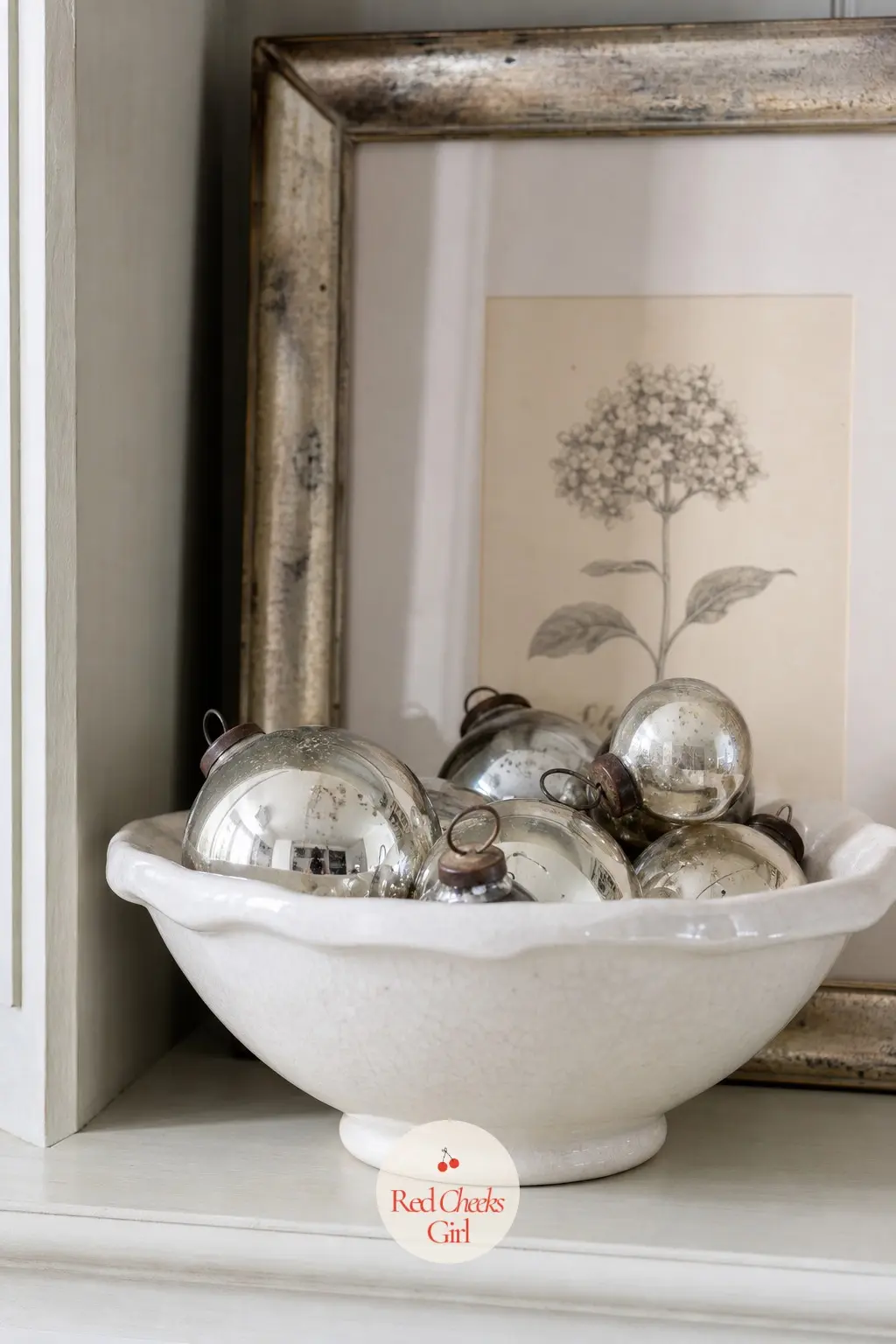 Silver Ornaments Nested in a Ceramic Bowl With a Tarnished Frame — No tree, no village, just a shallow white ceramic bowl filled with a loose nest of silver