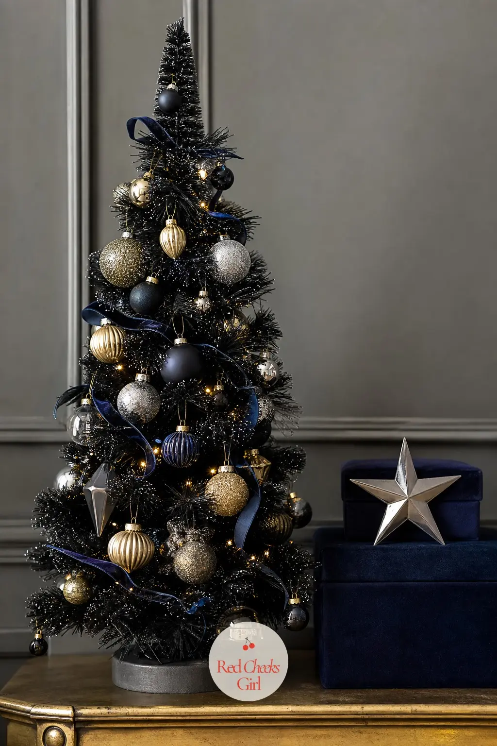 A Single Black Bottle Brush Tree With Pewter Star and Velvet Boxes — One tree, placed off centre rather than in the middle, reads as more considered than a