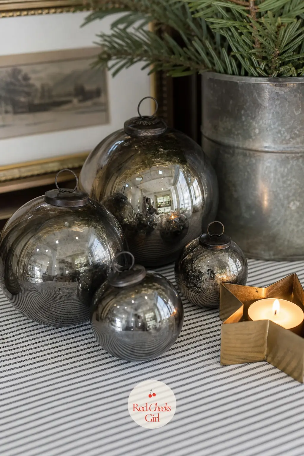 Smoked Glass Ornaments on a Ticking Stripe With a Brass Star Candle — Line the back of the shelf with a strip of black and white ticking stripe fabric, then