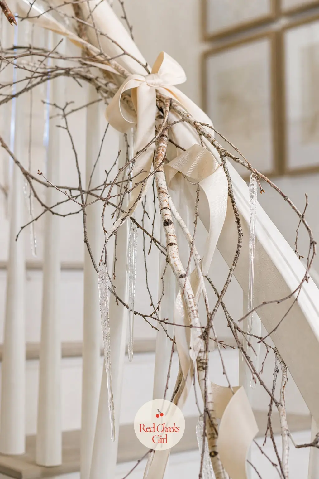 A Bare Birch Branch Garland Wound With Ivory Grosgrain Ribbon and Glass Icicles — Thin birch branches, left bare rather than flocked, wind down the rail in