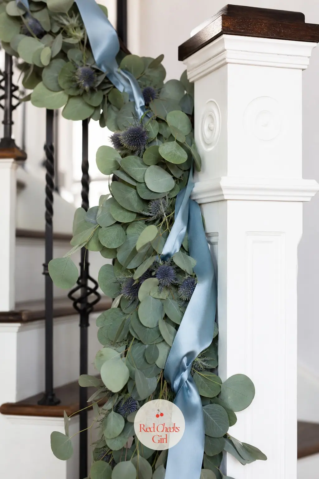 A Eucalyptus and Blue Thistle Rail Twined With Dusty Blue Satin Ribbon — Fresh eucalyptus stems run the length of the rail with dried blue thistle heads tucked